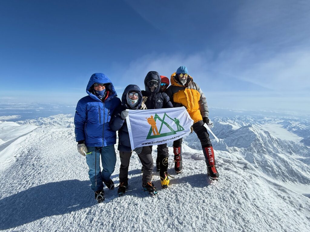 Ian Taylor Trekking Logo on Denali On the summit of Denali